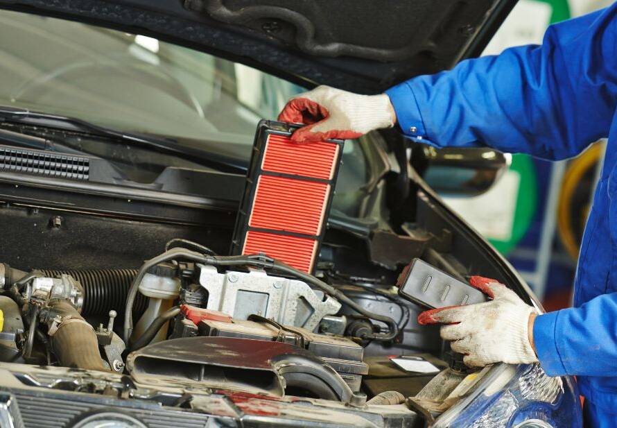 Mechanic replacing air filter in Birmingham, AL at Auto Repair 74